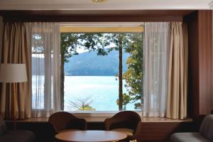 a large window with a view of a lake at The Prince Hakone Lake Ashinoko in Hakone