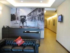 a lobby with a couch and a wall with a picture at Fargo Boutique Hotel in Kuantan