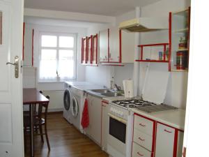 a kitchen with a sink and a stove top oven at Pokoje Gościnne Irene in Poznań