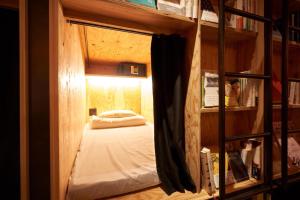 a small bedroom with a bunk bed in a room at Book And Bed Tokyo Shinjuku in Tokyo