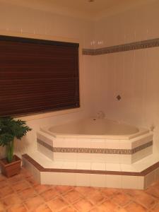 a large bath tub in a room with a window at Blackwattle at Barrington Tops in Bandon Grove