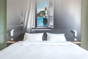 Postel nebo postele na pokoji v ubytování B&B HOTEL Lorient Caudan