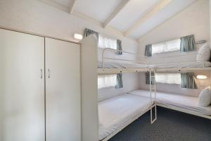 a bedroom with two bunk beds in a room at Benalla Tourist Park in Benalla