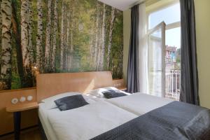 Un pat sau paturi într-o cameră la Hotel Scaletta