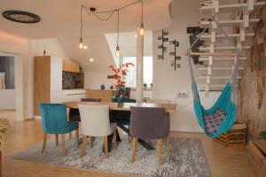 a dining room with a table and chairs at Vintage Design Apartment in Gornja Radgona