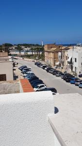 a row of cars parked in a parking lot at Aquamarine Apartment Nel Cuore Di San Vito in San Vito lo Capo