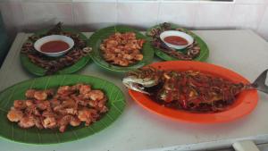 a table with plates of food and bowls of food at Yulia Resort in Sabang +47 photos