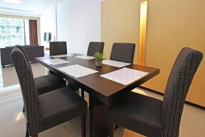 a conference room with a wooden table and chairs at Bernard Holiday Home @ Imperial Suites Kuching in Kuching +33 photos