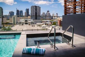 a swimming pool on the roof of a building at Ivy and Eve Apartments by CLLIX in Brisbane