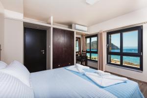 A bed or beds in a room at Villa Menelaos