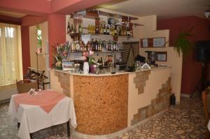 a restaurant with a bar with a table in a room at Pensiunea La Palaguta in Baia Mare