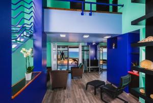 a lobby with blue and green walls and chairs at Villa Menelaos in Mochlos