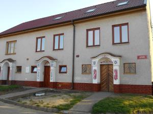a brick house with two doors and a garage at Penzion Imrichovi in Moravská Nová Ves