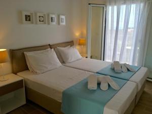 A bed or beds in a room at Alegria Kefalonia