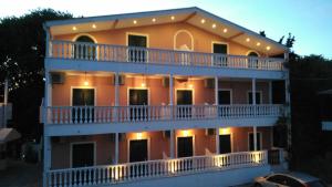a large apartment building with lights on its balcony at Infinity blue beach apartments in Tsilivi