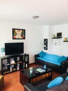 salon z kanapą i telewizorem w obiekcie Just like your home w mieście Bahia de Casares