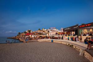 a group of people on a beach near the ocean at You & Me in Jávea