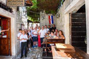 a group of people standing next to a building at Heritage Hotel Tragos in Trogir