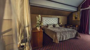 a hotel room with a bed and a table at Park-Hotel Golosievo in Kyiv