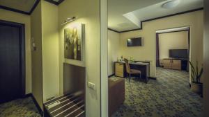 a hotel room with a desk and a room at Park-Hotel Golosievo in Kyiv