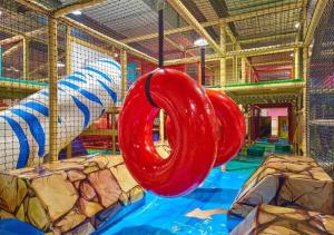 a playground with two red swings in a room at Shangri-La Dalian in Dalian