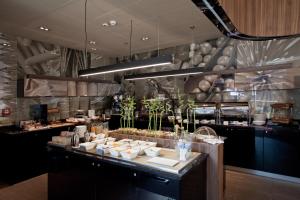 a restaurant with a counter with food on it at Qubus Hotel Bielsko-Biała in Bielsko-Biała
