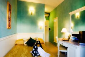 a room with a couch and a desk with a computer at Hotel Bright in Rome +22 photos