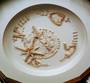 a white plate with various objects on it at Letuchiy Gollandets in Uzhhorod