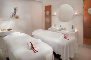 a spa room with two beds and a mirror at Villa Agrippina Gran Meliá – The Leading Hotels of the World in Rome