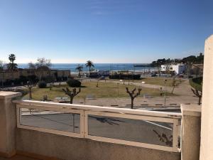 a balcony with a view of a park and the ocean at Cala Azul 304-306 Tamarit in Tamarit