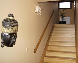 a stairway with a statue of a head on the wall at Asian Zen in Místek