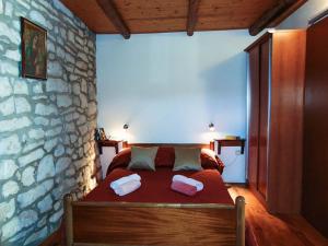 a bedroom with a bed with two towels on it at Mario (RADE) in Korčula