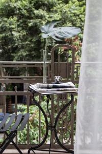 a table with a glass vase on it next to a chair at The Modernist Thessaloniki in Thessaloniki