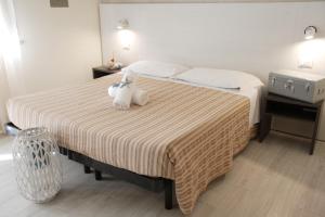 Postel nebo postele na pokoji v ubytování Hotel Tosi