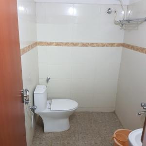 a bathroom with a toilet and a sink at Surag Residency in Tiruchchirāppalli