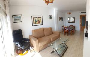 a living room with a couch and a chair at Cala Azul 304-306 Tamarit in Tamarit