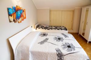 a bedroom with two beds and a painting on the wall at Casa Moiser in Tresenda