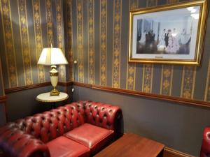 a living room with a couch and a lamp at Shap Wells Hotel in Shap