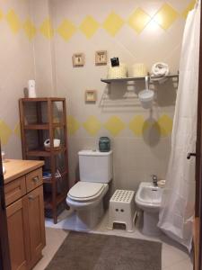 a bathroom with a white toilet and a sink at Casa de férias Josefa D´Óbidos in Óbidos