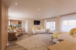 a large living room with two beds and a living room at The Aviary in Pretoria