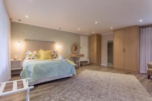 a bedroom with a large bed with yellow pillows at The Aviary in Pretoria