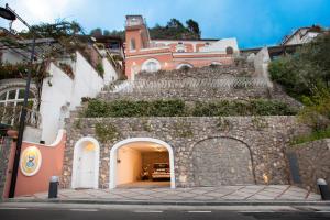 a building with an archway in front of a building at Il Moro Di Positano in Positano