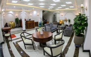 a lobby with chairs and a table in a building at Khách sạn Vĩnh Hội in Pleiku