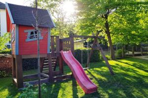a playground with a slide and a play house at Apartment Tivoli Park in Ljubljana