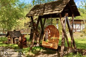 a small wooden play structure with a small house at Hotel Complex Kupava in Podvorki