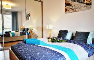 Posteľ alebo postele v izbe v ubytovaní SPA Polanki PARK Nemo Apartamenty Kołobrzeg