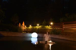 a large white ball in the water at night at Penzion Šterk in Most na Soči