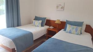 a room with two beds with blue and white at Mira Parque in Albufeira