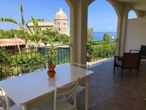 a white table and chairs on a balcony with a view at Residenza Azzurra in Tropea