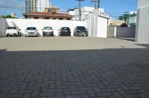 a group of cars parked in a parking lot at Annamar Hotel in João Pessoa